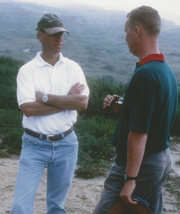 Two men talking on a golf course